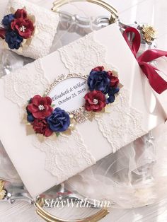 two cards with red, white and blue flowers on them are sitting on a table