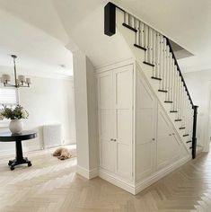 an empty room with white walls and wooden floors