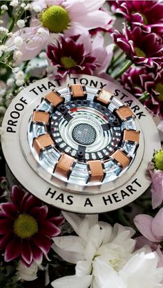 a close up of flowers with a circular object in the center surrounded by words that read, proof that tomorrow has a heart