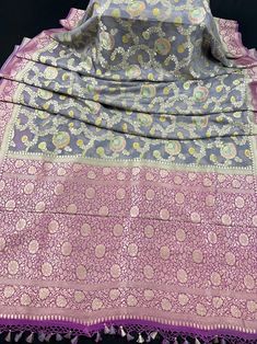 Pure Moonga Banarasi Silk Handmade Saree with Floral Jaal with Brush Paint. Item : SareeBase Fabric : Pure Moonga Banarasi SilkColor : Grey and Pink Blouse piece : Comes with un-stitched Blouse piece.Fall & Edging(Yes/No) : Yes Disclaimer :-- Color variation is possible due to various reasons like phone or desktop setting, resolution etc. Please don't hold us responsible. Our aim is to put the exact color of the Saree.- If the Saree is Pure Silk, we will put it very clearly in our listing that i Purple Jamawar Saree, Purple Jamawar Traditional Wear With Cutdana, Purple Jamawar Traditional Wear For Diwali, Purple Meenakari Jamawar Saree, Purple Meenakari Art Silk Dupatta, Purple Banarasi Silk Traditional Wear For Eid, Semi-stitched Purple Jamawar Saree, Purple Jamawar Saree With Self Design, Purple Zari Work Dupatta For Transitional Season