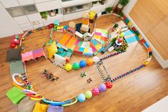 an overhead view of a child's play room with toys on the wooden floor