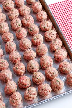 raw meatballs on a baking sheet ready to be cooked