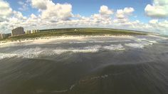 an aerial view of the beach and ocean from a kite boarder's perspective