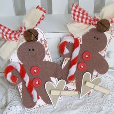 two brown teddy bears with red and white bows