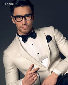 a man in a tuxedo and bow tie poses for a magazine cover photo