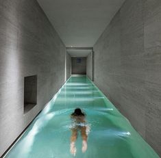 a person is swimming in a long pool