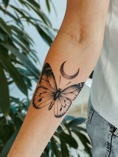 a man with a butterfly tattoo on his arm