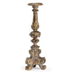 a tall metal candle holder with ornate carvings on the top and bottom, sitting against a white background