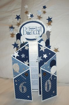 a blue and white birthday card with stars on the top, in front of a white background