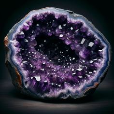 an amethorate with purple and white crystals in the center on a black background