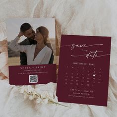 save the date calendar card on top of a white blanket with a rose in it