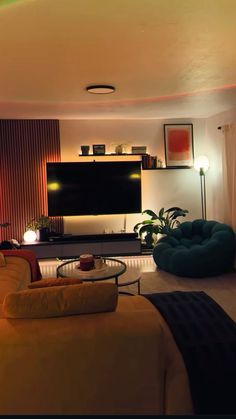 a living room filled with furniture and a flat screen tv mounted to the side of a wall