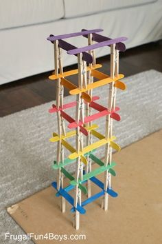 a multicolored wooden structure sitting on top of a rug