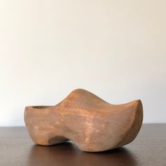 a wooden object sitting on top of a table