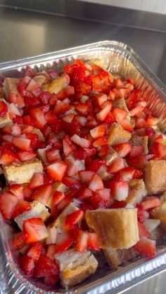 strawberries and toasted bread in a plastic container