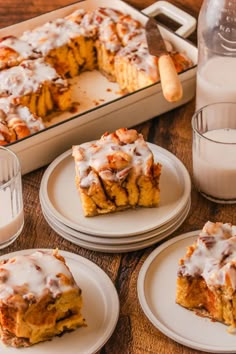 there are four plates with desserts on them next to a bottle of milk and a glass of milk