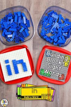 three plastic containers filled with legos and building blocks on top of a wooden table