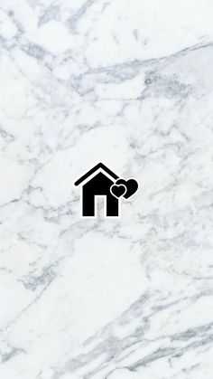 a black and white photo of a house with a heart in the middle on a marble background