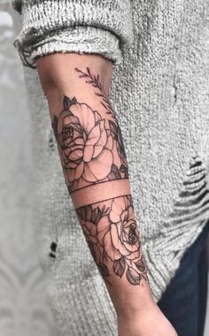 a woman's arm with flowers on it