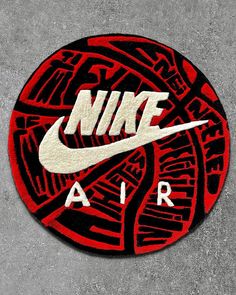 a red and black nike air logo on cement