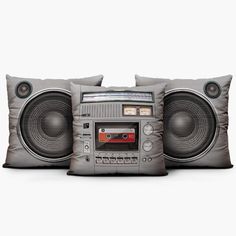 three pillows with an old school boombox on them, one in grey and the other in red