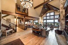 a large living room with wooden floors and high ceilings