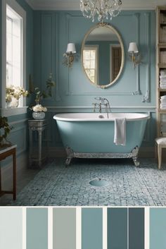 a bathroom with blue walls and white fixtures, including a claw foot bathtub in the center