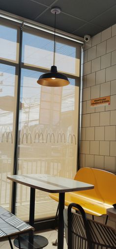 a table and chairs in front of large windows