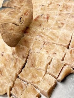 a cutting board that has some kind of food on it with a knife sticking out of it