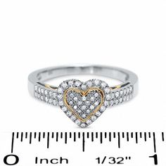 Everything you love about her can be expressed through this romantic 10K two-tone gold heart-shaped ring. The gleaming white gold design is covered in round diamonds and accented by rose gold swirls inside the shank and a matching heart outline at the center. Be prepared to turn heads in this 1/3 ct. t.w. diamond fashion favorite. Heart Outline, Heart Shaped Rings, Diamond Fashion, Gold Heart, Gold Design, Heart Of Gold, Pave Diamonds, Round Diamonds, Heart Ring