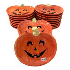 four pumpkins with faces painted on them are stacked in front of each other,