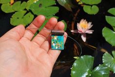 Water Lilies Enamel Necklace  Fully handmade   Copper, Silver, enamel Pendant width 2 centimeters  Pendant height 3 centimeters Black Enamel Necklace For Gift, Gift Black Enamel Necklace, Hand Painted Enamel Jewelry Gift, Hand Painted Enamel Jewelry For Gifts, Turquoise Enamel Jewelry Gift, Hand Painted Enamel Pendant Necklace, Enamel Rectangular Pendant Jewelry Gift, Enamel Rectangular Pendant Jewelry For Gift, Artistic Enamel Necklaces As Gift