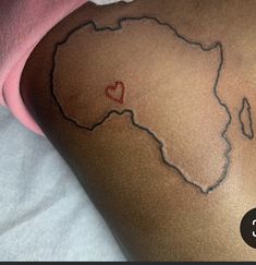 a person with a tattoo on their back that has a heart in the shape of africa