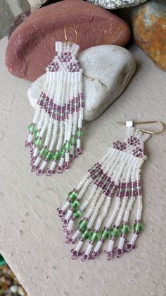 Long Beaded Fringe Earrings.  Comanche Brick Stitched Glass Beaded Earrings in the colors of White Frost, Peridot Green & Purple Amethyst.   Earrings are made entirely of glass beads:  Seed Beads, Bugle Beads and 4mm Peridot Green round glass beads.  Gold Plated Surgical steel ear wires for pierced ears. Length: 3 1/4" (from top of ear wire to bottom of earring).   Width: 1" at widest when worn on the ear. Handcrafted by artist Hanan Hall.   Ships First Class USPS (includes domestic tracking #) from a smoke-free environment. Thank you for visiting www.etsy.com/shop/thefoxandfilly  -  Please favorite my shop as I am continually adding unique & lovely pieces you may not want to miss!  And additional jewelry items in your order qualify for shipping discounts! Please review Shop Policies BEFOR Beaded Earrings Native, Native American Earrings, Peridot Green, Western Cowgirl, Bugle Beads, Green Peridot, Earrings White, Beaded Fringe, Seed Bead Earrings