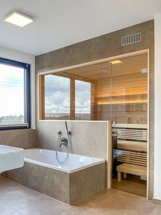 a bathroom with a large tub next to a window