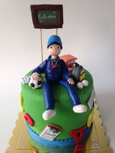 a cake with a boy sitting on top of it and a sign in the background