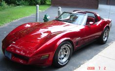 a red sports car parked in front of a house