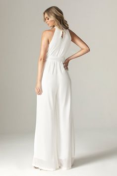 Feminine, floaty and perfect for Spring. Cut from breezy georgette chiffon for a fresh feel in elegant ivory, 'Fadia’ has a wide belt to cinch the waist . The classic halter shape silhouette and accentuates the figure whilst prioritizing luxurious comfort. and we love how the pleated waist falls to a flared long hem for feminine flair.It's fully lined for comfort and zips up the back for easy on. Wear yours with delicate accessories like our 'Adrien' necklace.WHERE TO WEAR:Pretty date nights, bo Elegant Summer Jumpsuits And Rompers With Tie Waist, Elegant Belted Solid Jumpsuits And Rompers, Chic Fitted Chiffon Jumpsuit, Chic Fitted Chiffon Jumpsuits And Rompers, Elegant Belted Jumpsuits And Rompers For Summer, Elegant Chiffon Jumpsuits And Rompers For Spring, White Jumpsuits And Rompers For Summer Wedding Guests, Elegant Summer Wedding Jumpsuits And Rompers, Elegant Flowy Jumpsuits For Summer