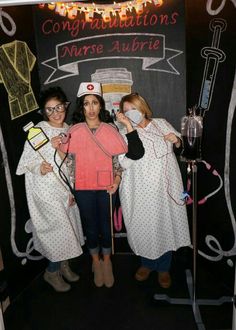 three women dressed up as nurses in front of a blackboard with congratulations written on it