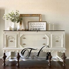 a white dresser with two drawers and a sign on top that says beauty written in cursive writing