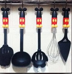 mickey mouse kitchen utensils hanging on the wall