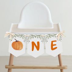 a one year old baby's first birthday banner with an orange pumpkin on it