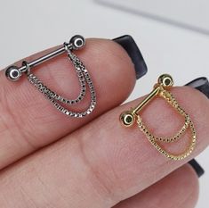 a person holding two different types of rings on their fingers, one is gold and the other is silver