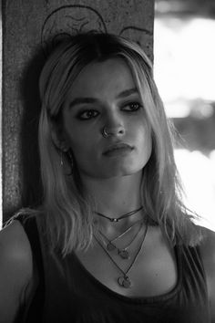 black and white photograph of a woman with blonde hair wearing necklaces on her neck