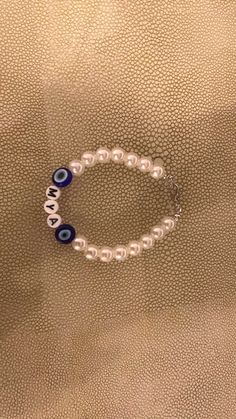 Customised Pearl Evil Eye Bracelet Handmade  Message me for requires  instagram - @jewellerybymya Beaded Braclets, Bracelet Keychains, Diy Jewelry Unique, Bracelets Design, Bracelet Pearl, Bead Charms Diy, Diy Bracelets Patterns, Beads Bracelet Design, Handmade Jewelry Tutorials