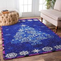 a blue rug with snowflakes on it in front of a couch and chair