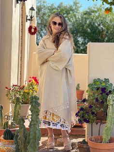 This super soft boiled wool kimono coat is the perfect neutral staple for your wardrobe. This kimono coat is super lightweight yet keeps you warm, and it is wonderfully fun to wear over just about anything! The best part about it is that it goes over all of our PAX dress silhouettes. It flatters every figure and every height. To top it all off, you can wear it on whichever side you prefer as this item is completely reversible, adding even more options to your wardrobe! The use of boiled wool for Oversized Beige Lagenlook Outerwear, Oversized Bohemian Cream Outerwear, Bohemian Oversized Cream Outerwear, Bohemian Cream Oversized Outerwear, Spring Lagenlook Long Sleeve Poncho, Spring Long Sleeve Robe With Natural Dye, Oversized Wrap Kimono For Fall, Cream Oversized Long Sleeve Poncho, Cream Long Sleeve Poncho For Fall