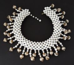 "This incredible collar necklace is unsigned, however, it is attributed to either Coppola e Toppo, Mimi D'N, or Hattie Carnegie. Whoever the designer, it is fabulous and done with incredible talent, artistry, and quality construction Look at the back side constructiongorgeous glass pearl bead strings are mounted onto a weft (like Coppola e Toppo) of glass pearls. The strings are made up of glass pearls, rhinestone rondelles, and rhinestone rondelle balls. There is some color wear to the gold pla Luxury White Necklaces For Party, White Costume Jewelry Necklace With Jewels, Luxury White Necklace For Party, Glamorous White Jewelry For Celebrations, Luxury White Pearl Necklace For Party, White Luxury Necklace For Evening, Luxury White Necklace For Evening, Glamorous White Beaded Pearl Necklace, Vintage White Necklaces With Jewels