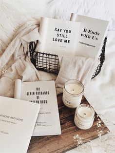 some books and candles on a bed