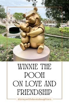 winnie the pooh statue sitting on top of a pedestal in front of a pond